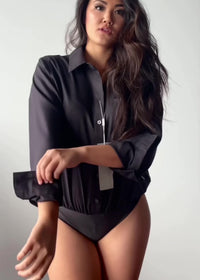 Model wearing non-iron relaxed fit bodysuit for women in charcoal black